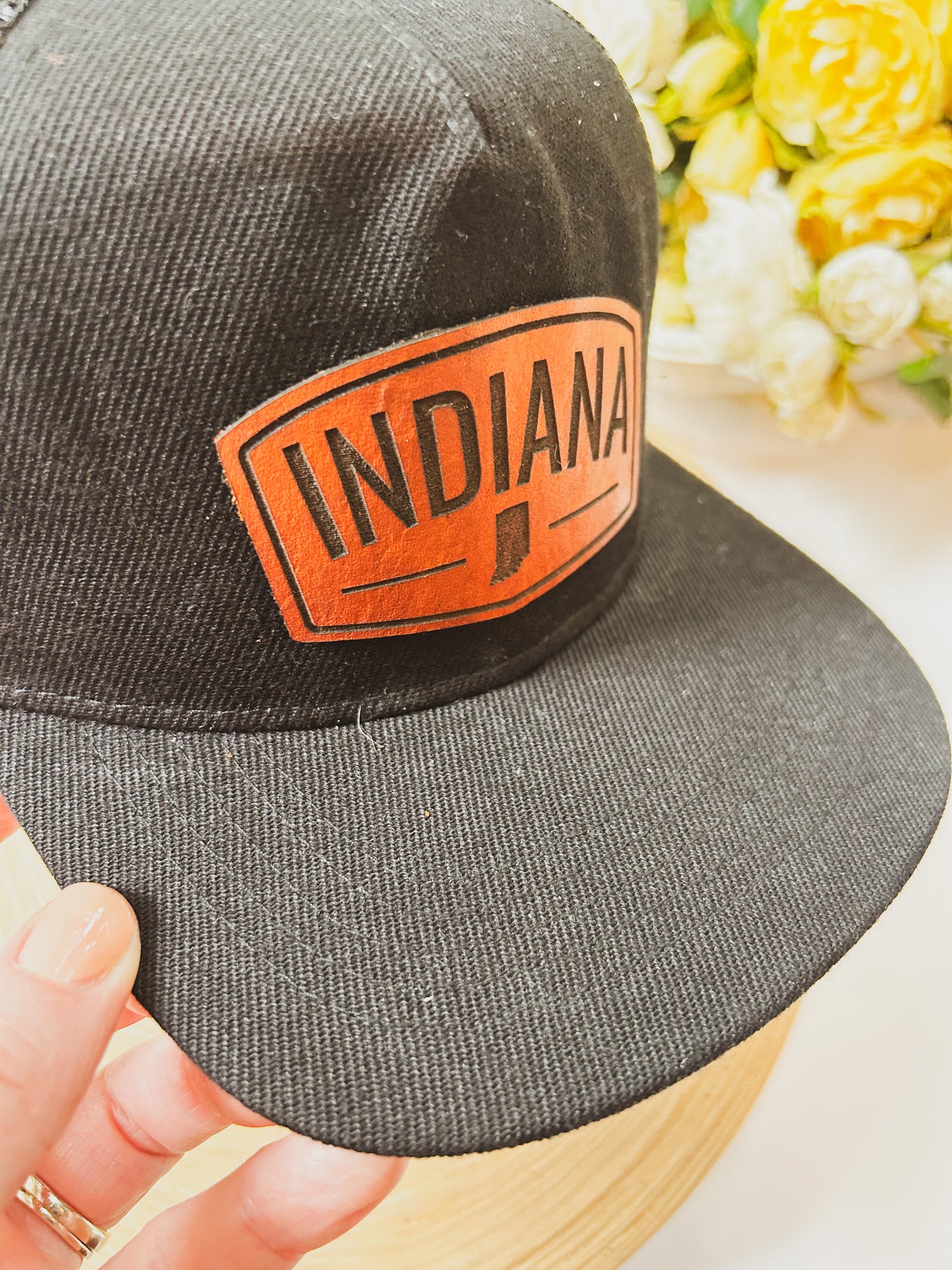 Rectangular Indiana Leather Patch on Black Trucker Hat