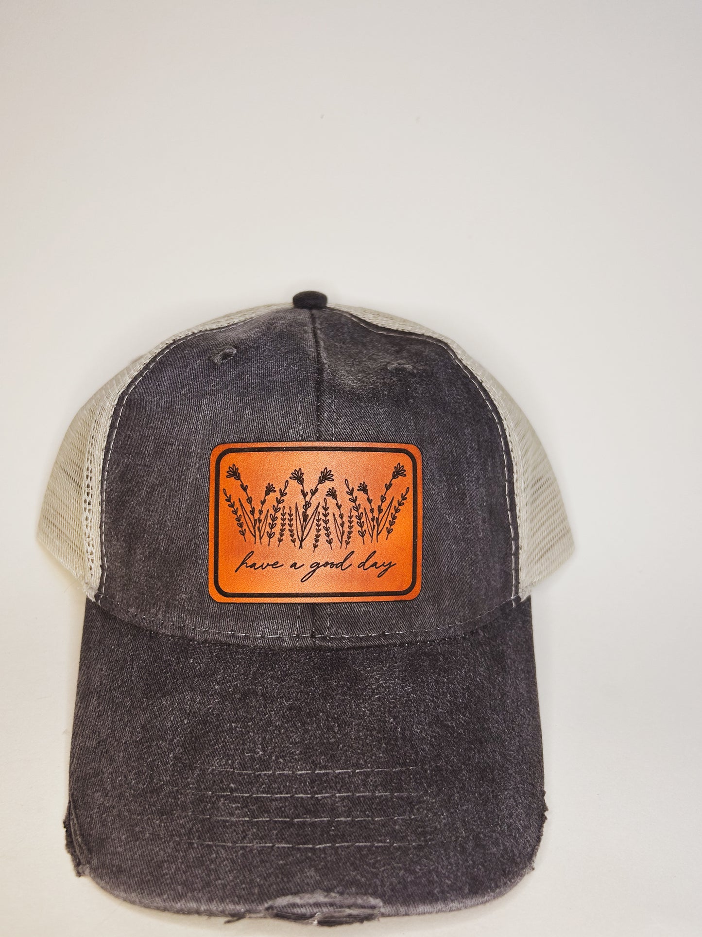 Have A Good Day Wildflower Leather Patch on Distressed Charcoal Hat