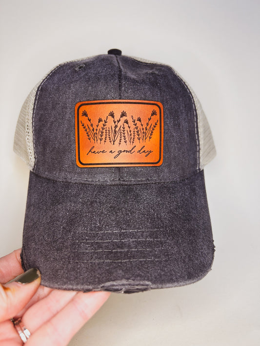 Have A Good Day Wildflower Leather Patch on Distressed Charcoal Hat